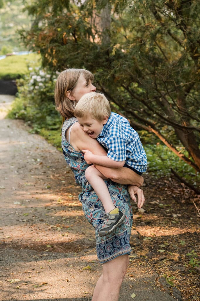 A grandmother holds her laughing grandson.